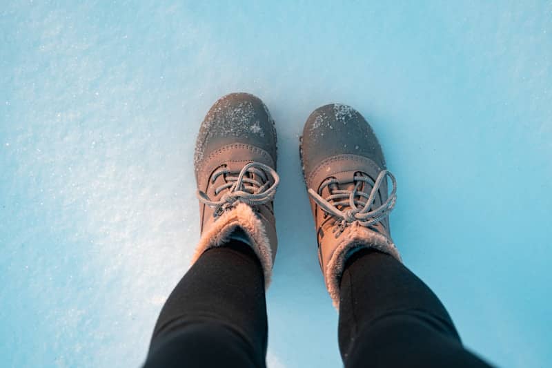 Pair of boots standing on snow