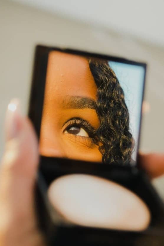 a woman holding a compact compact compact compact compact compact compact compact compact compact compact compact