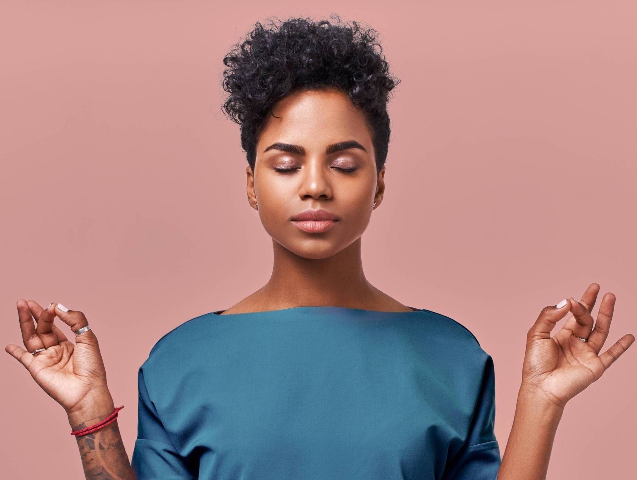 Woman with a peaceful look on her face meditating.