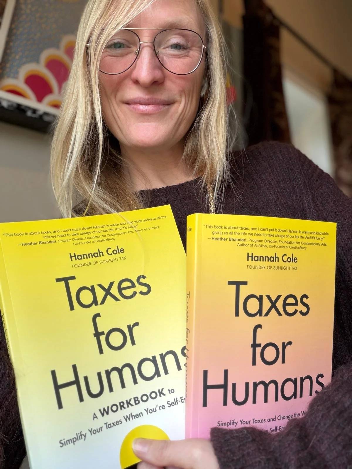 Hannah Cole holding her book Taxes for Humans