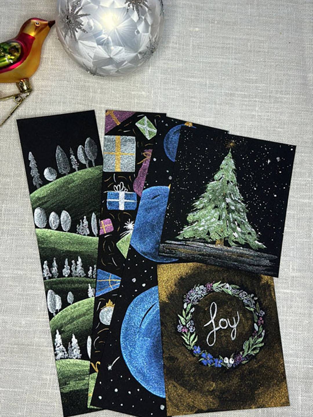 set of watercolor bookmarks with a Christmas theme metallic paints on black paper