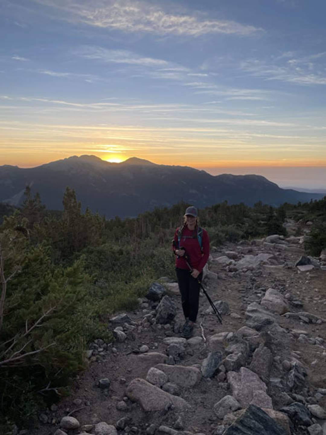 a hiking trail in the mountains at sunrise