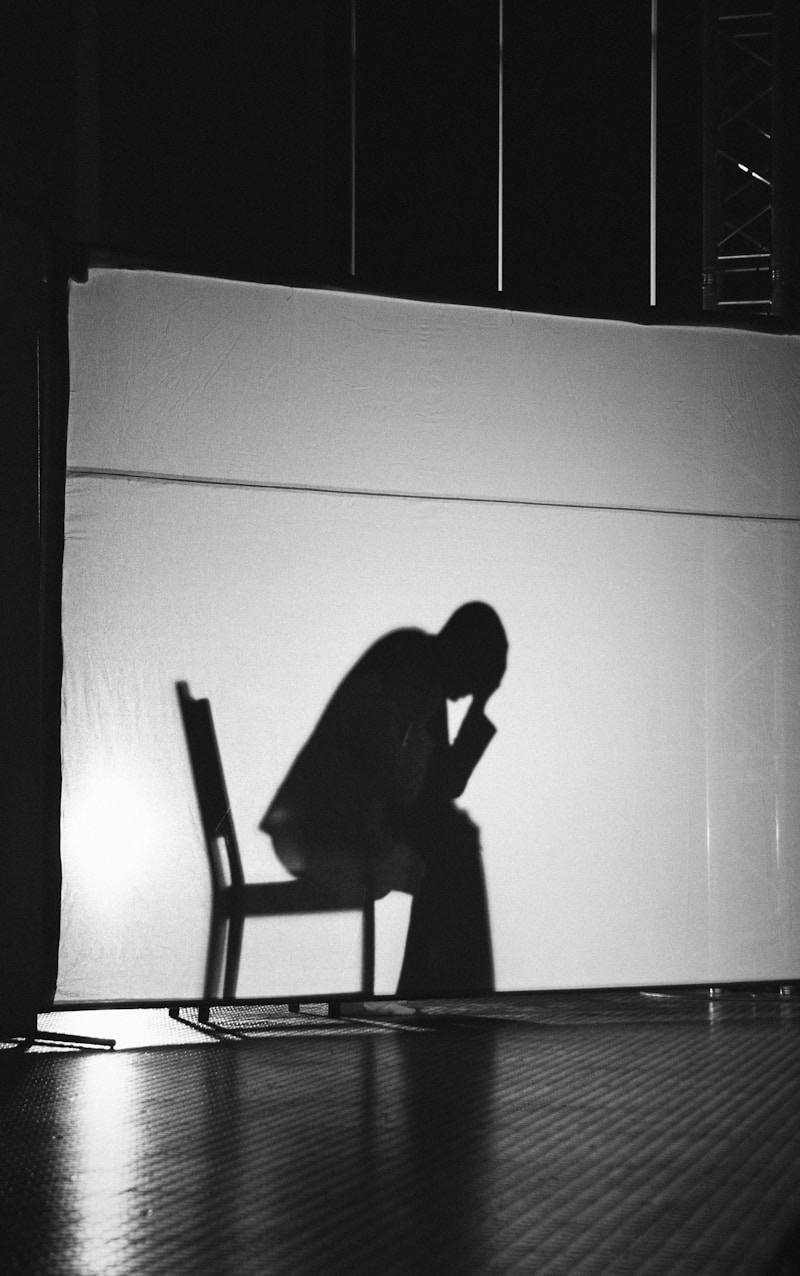 A black and white photo of a person sitting in a chair