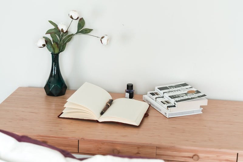 white book on brown wooden table