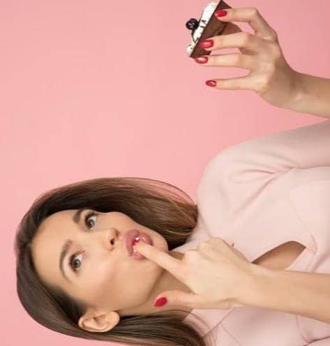 woman holding cake looking up