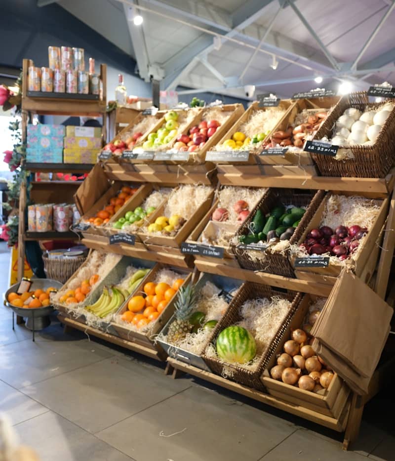 Fresh fruits and vegetables displayed in wooden crates.