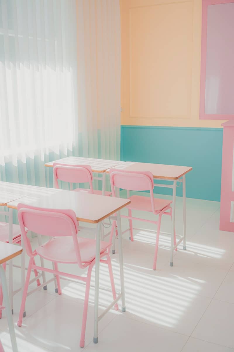 a room that has a bunch of pink chairs in it