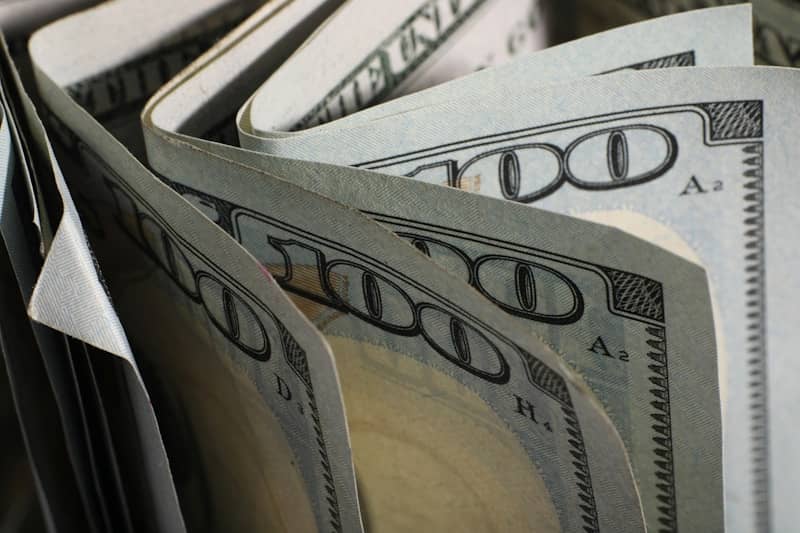 A close-up of us hundred dollar bills fanned out.