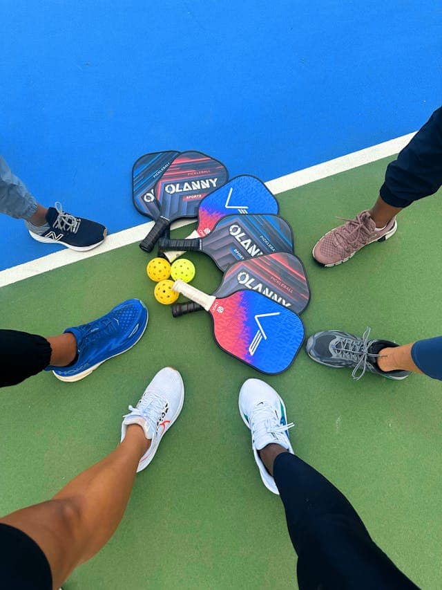 Photo by Danita White: https://www.pexels.com/photo/pickleball-paddles-gathered-on-court-in-st-george-35018223/