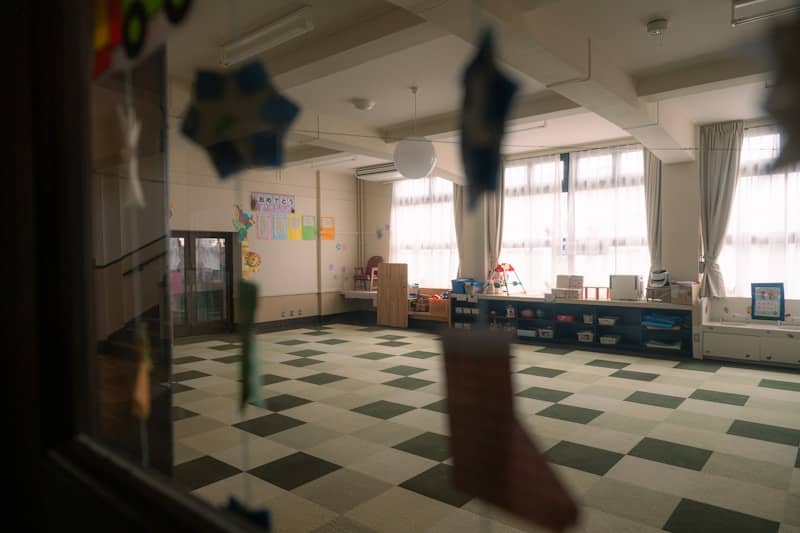 A large room with a checkered floor and lots of windows