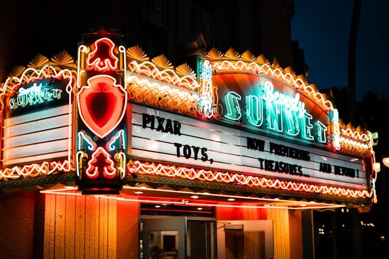 Vintage movie theater marquee advertising "pixar toys" at night.
