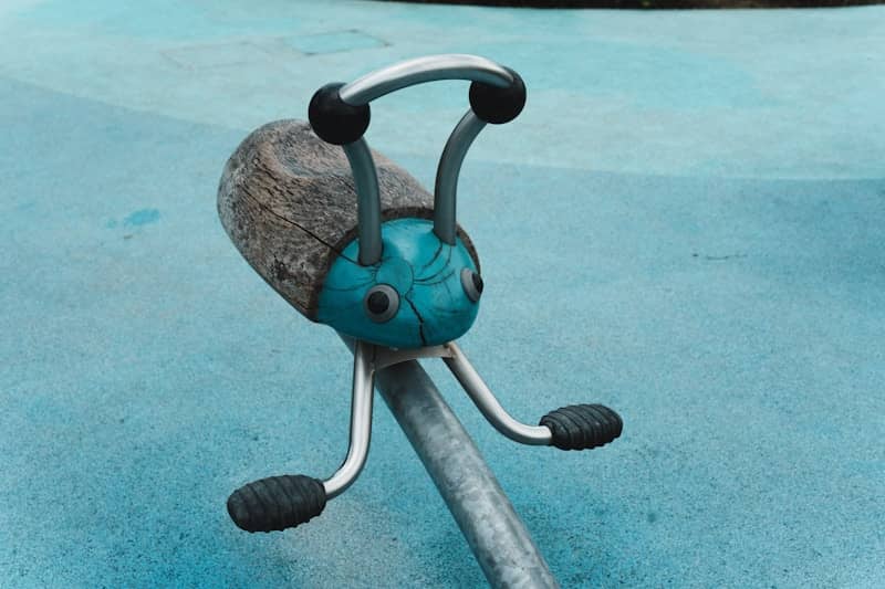 A blue and grey bug-shaped playground ride