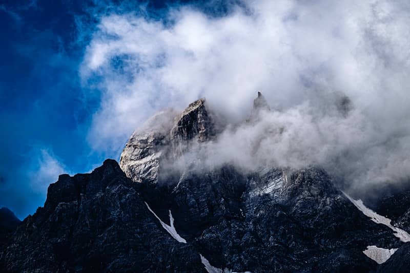 Misty mountain peak under a blue sky