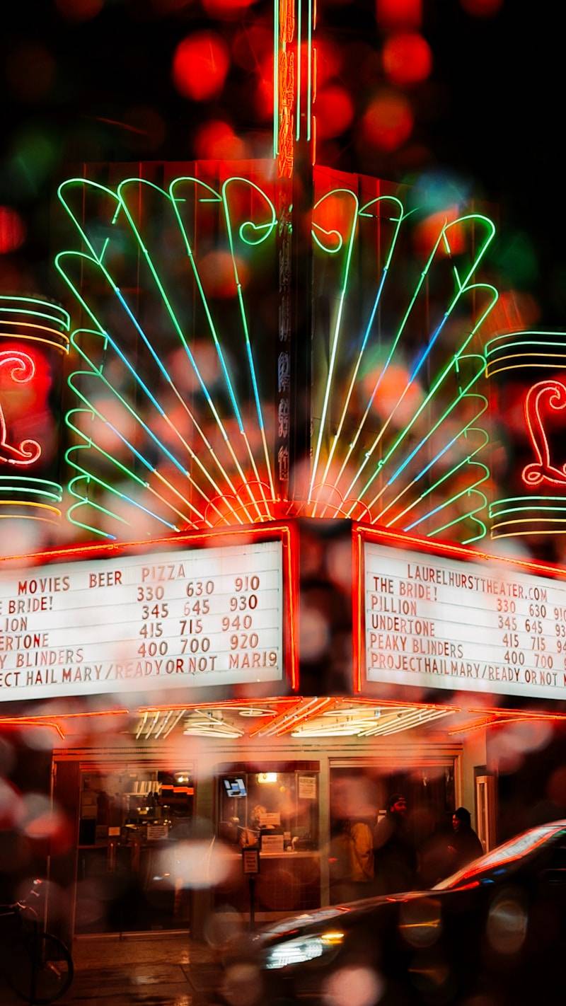 Neon marquee of a theater at night