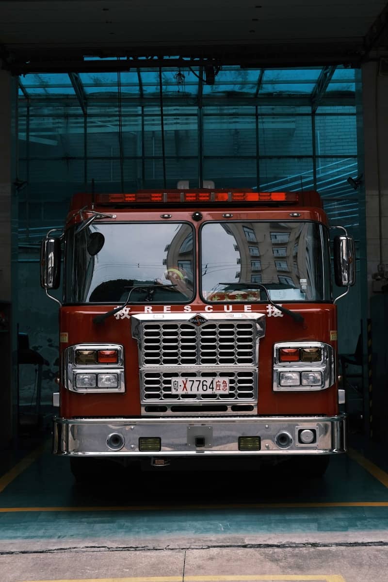 Red fire truck parked inside a station