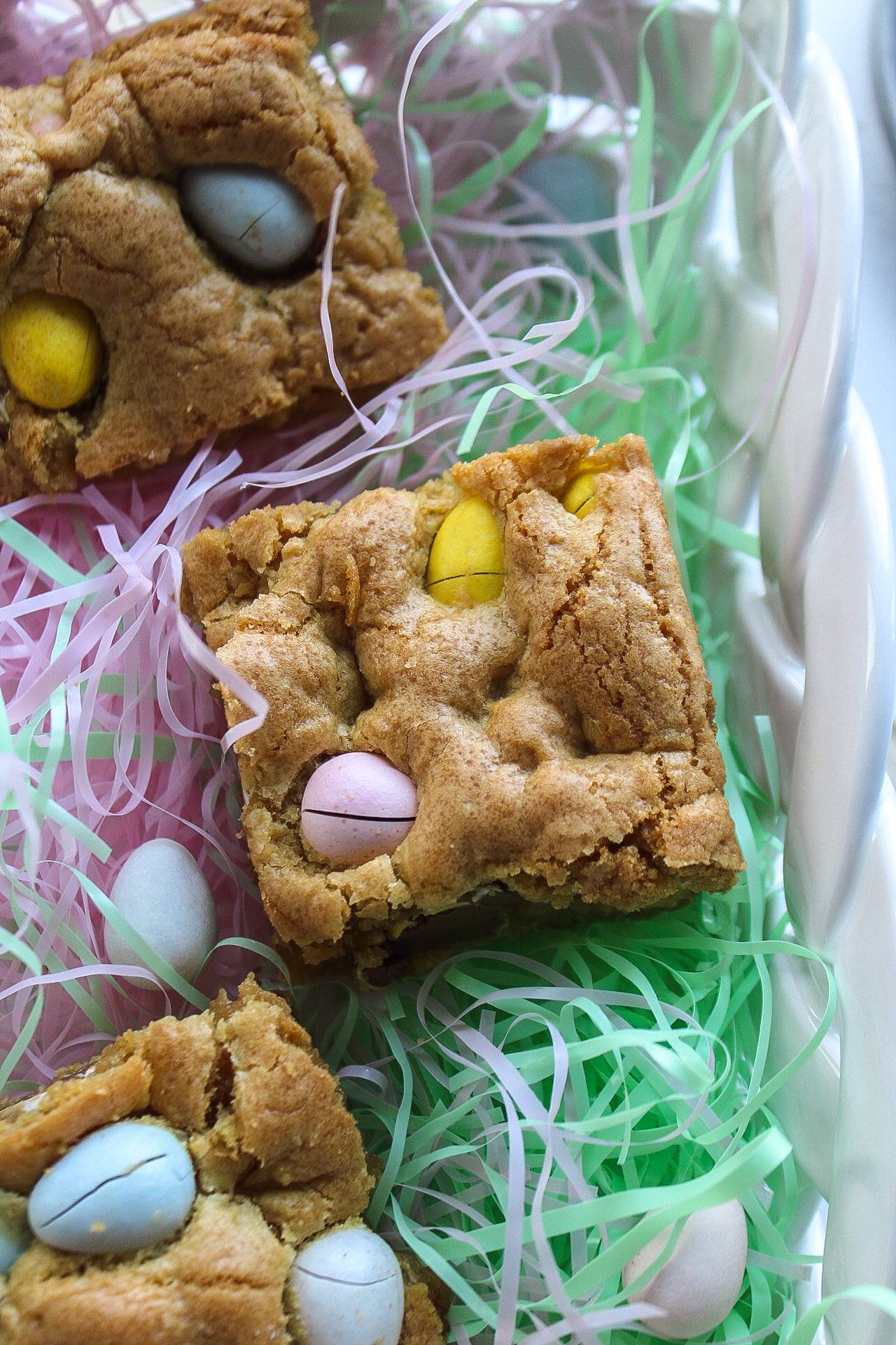 a blondie with cadbury eggs in an easter basket with easter grass