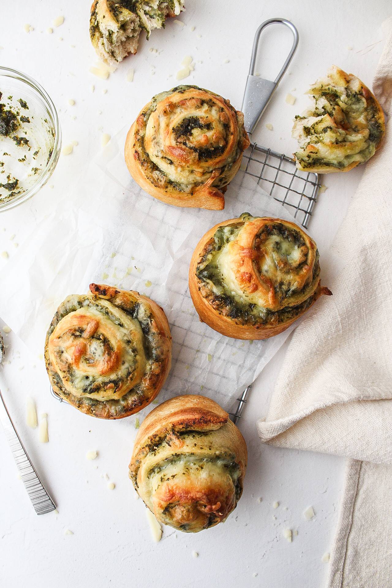 pesto pizza pinwheels on a cooling rack