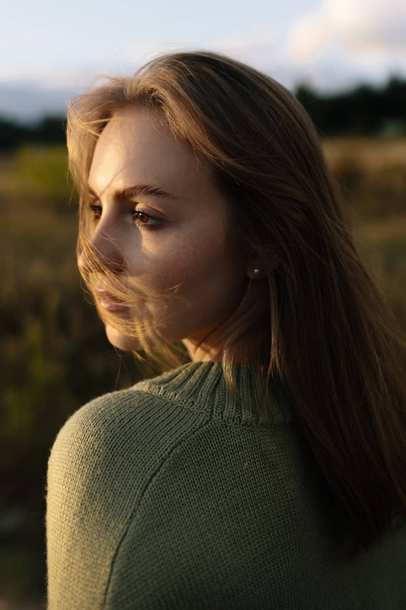 Young woman with windblown hair in a field