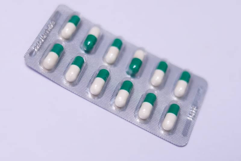 a pack of pills sitting on top of a white table