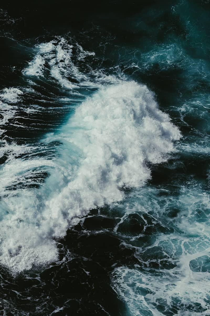 Powerful ocean wave crashing with white foam.