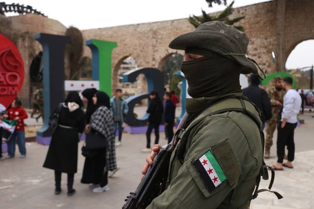 A Hayat Tahrir al-Sham (HTS) fighter provides security following the overthrow of Syrian government forces loyal to Bashar al-Assad, December 13, 2024. (Photo: Mohammad Bash/Shutterstock.com)