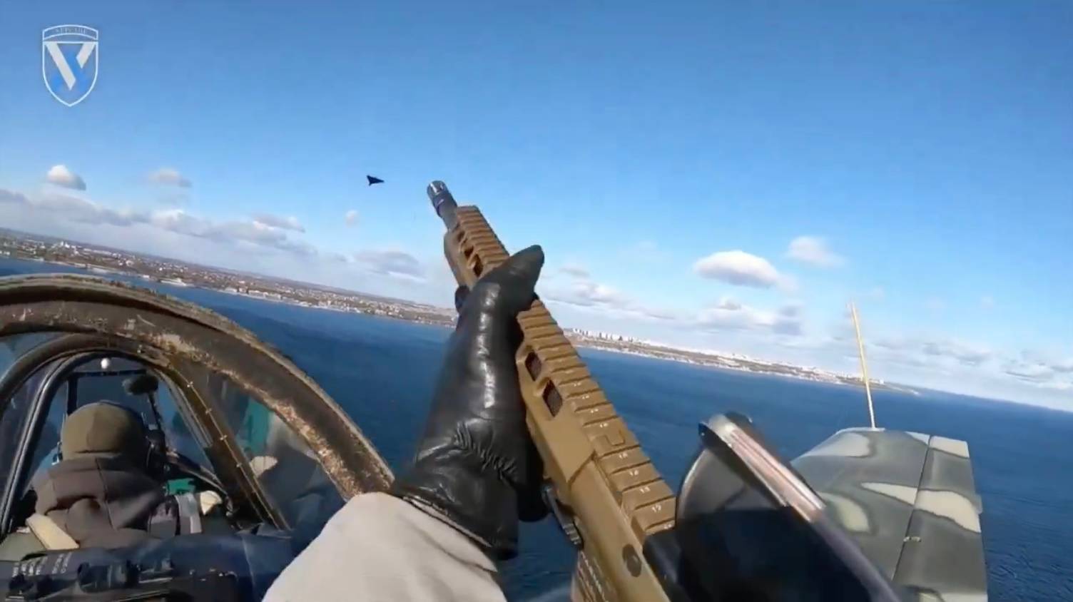 A gunner aboard a Ukrainian Yak-52 aircraft fires on a Russian Shahed drone with small-arms fire over the Odesa region. (Credit: Ukraine's 11th Separate Army Aviation Brigade)