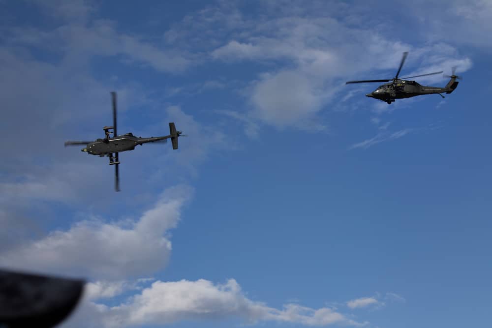 Two Colombian Air Force AH-60 Arpía helicopters in flight. (Julian HJ / Shutterstock.com)
