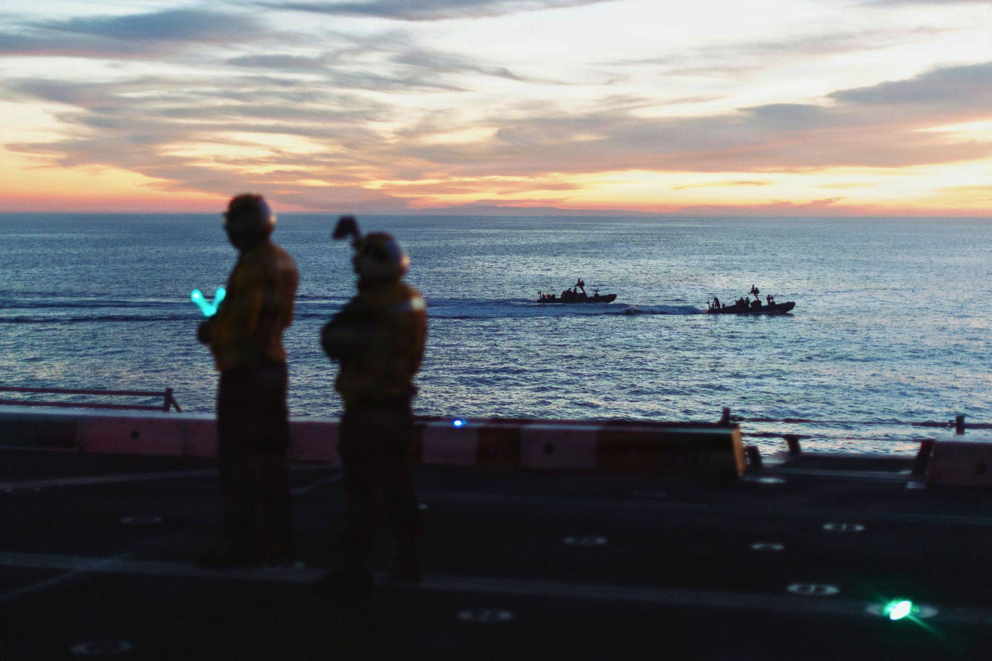 U.S. Marines with the Maritime Raid Force ride in rigid-hull inflatable boats alongside USS Portland during a VBSS exercise in the Pacific Ocean, March 1, 2026. (Credit: U.S. Marine Corps photo by Sgt. Joseph Helms)