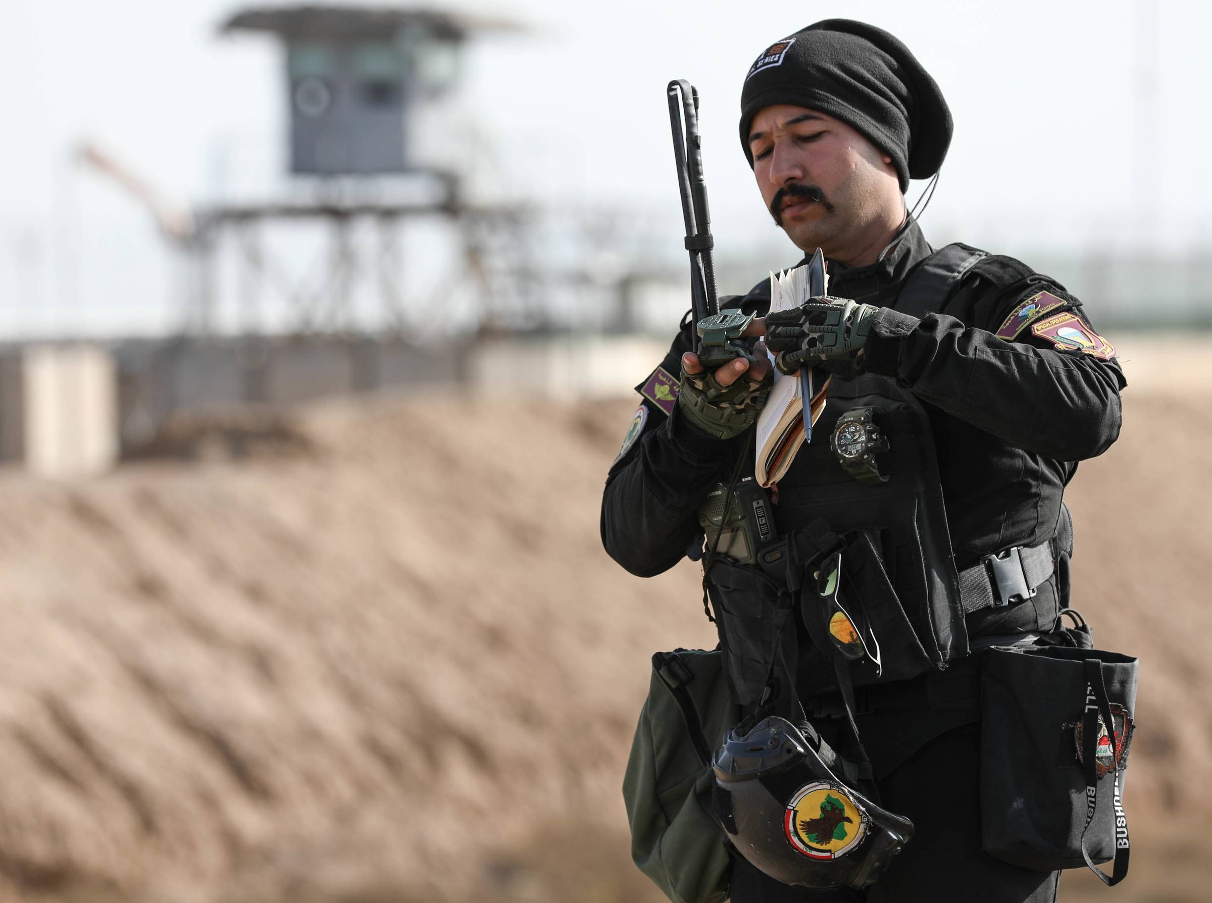 An Iraqi special operation forces member uses a compass to determine final attack headings during close air support training at Besmayah Training Center, Iraq, Dec. 30, 2019.