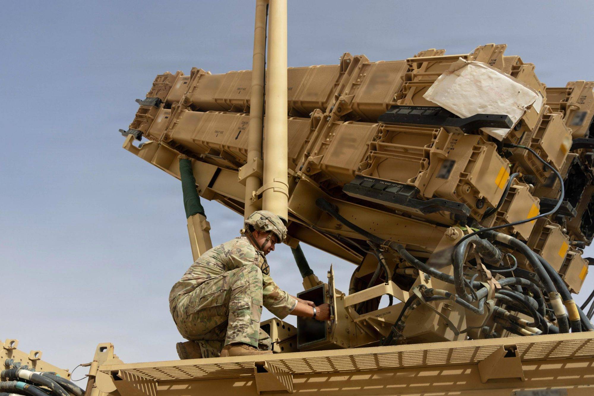 A U.S. Army air defense artilleryman conducts maintenance on an MIM-104 Patriot missile system in the Middle East. (Credit: US Department of Defense)