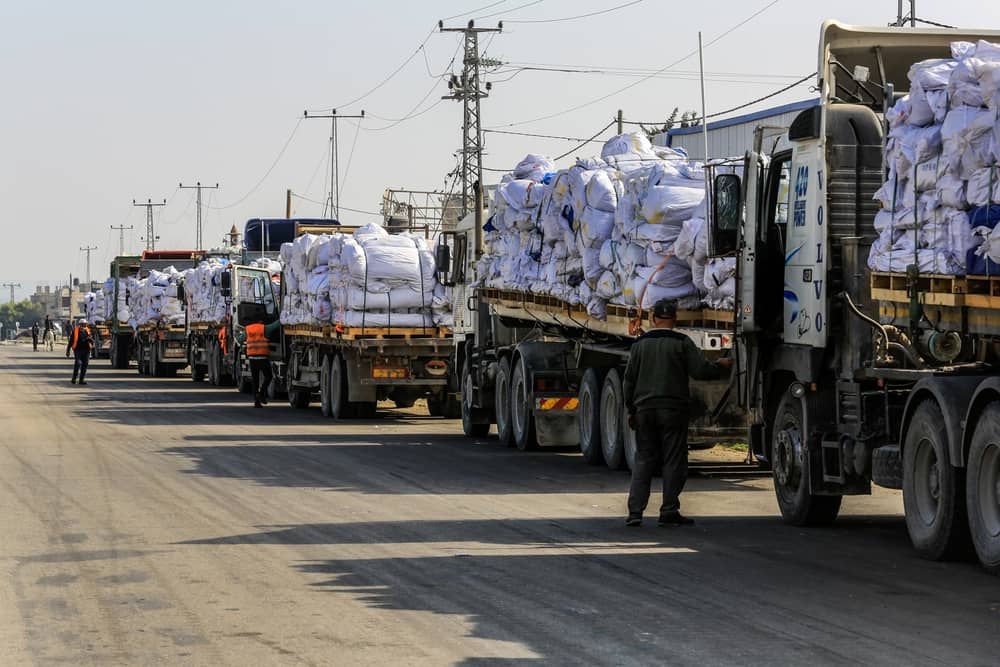  Trucks loaded with humanitarian aid preparing to cross through the Karem Shalom crossing into Rafah, Southern Gaza in February, 2025 (Anas-Mohammed / Shutterstock.com)