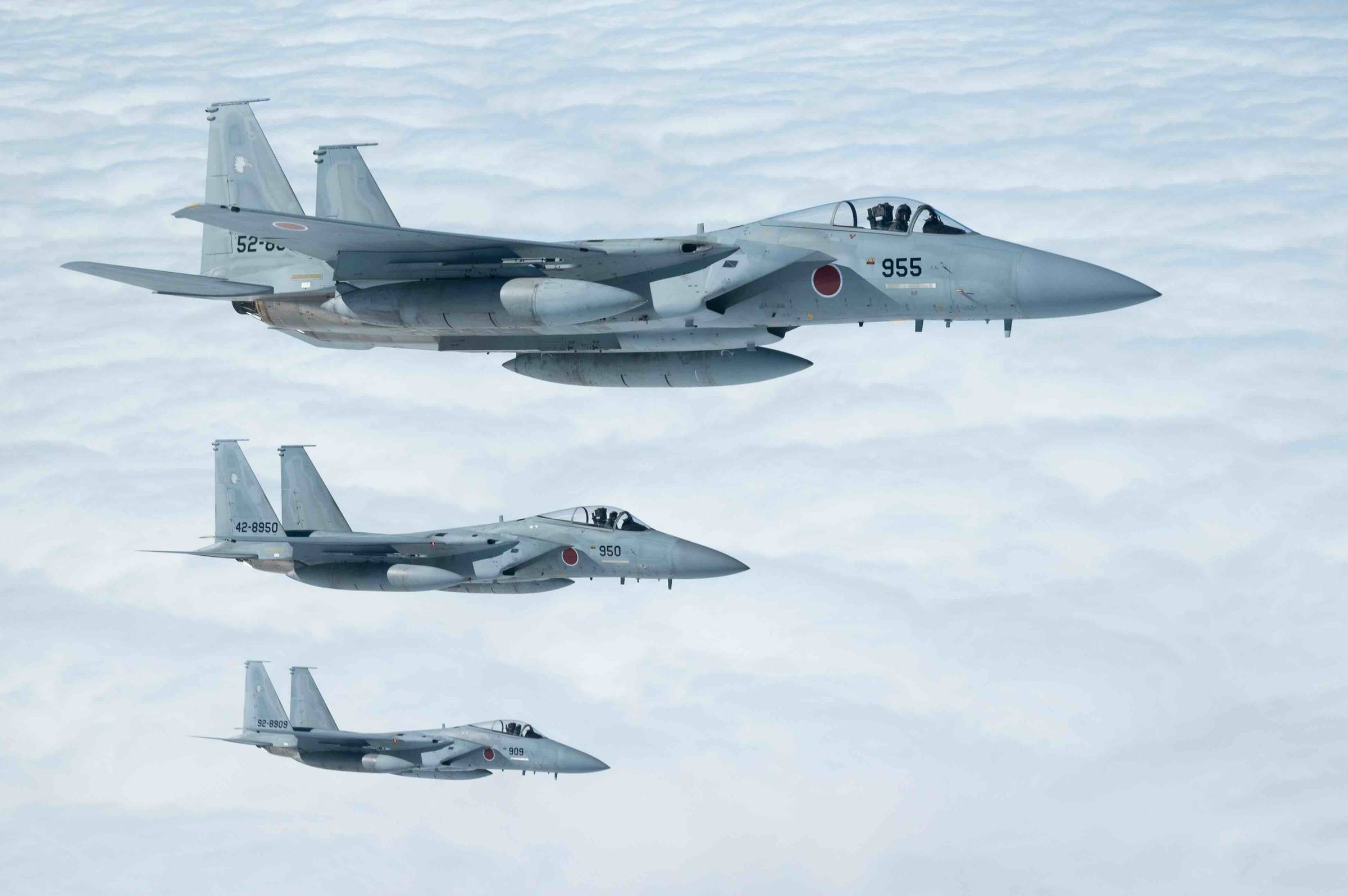 Three Japan Air Self-Defense Force F-15J Eagles fly alongside a U.S. Air Force KC-135 Stratotanker over the Pacific Ocean, Dec. 14, 2022 (U.S. Air Force photo by Senior Airman Yosselin Campos)