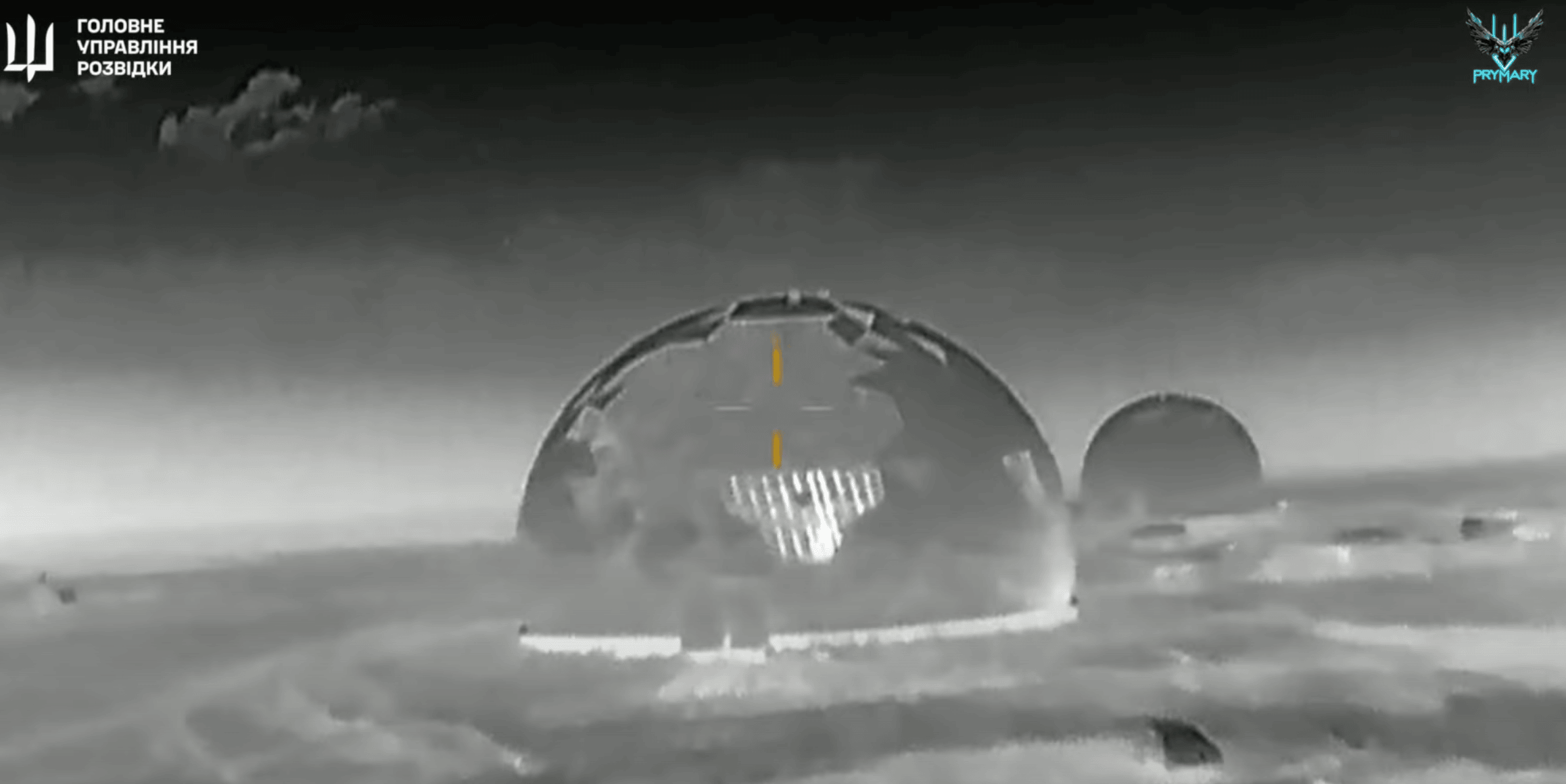 A screenshot from video released by Ukraine’s HUR “Prymary” unit shows an operation targeting a Russian air-defense radar installation concealed inside radio-transparent domes near the Crimean coast. The image captures a Nebo-SVU radar system under its do