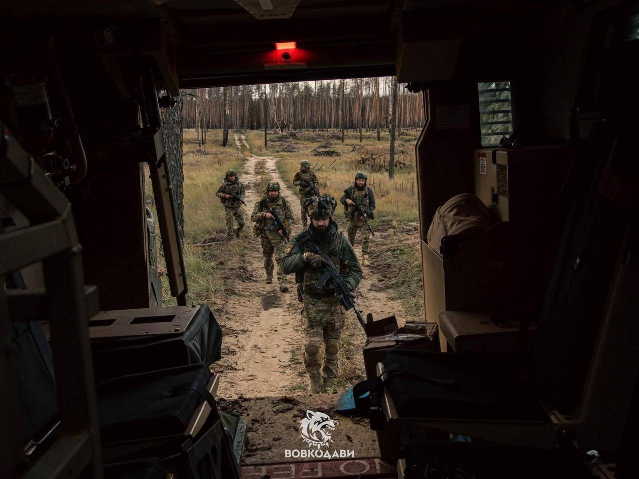 Soldiers of Ukraine's 57th Motorized Brigade approach a MaxxPro armored vehicle, designed to protect infantry against shelling, drones, mines, and ambushes. (Credit: Vovkodavy / 57th Motorized Brigade)