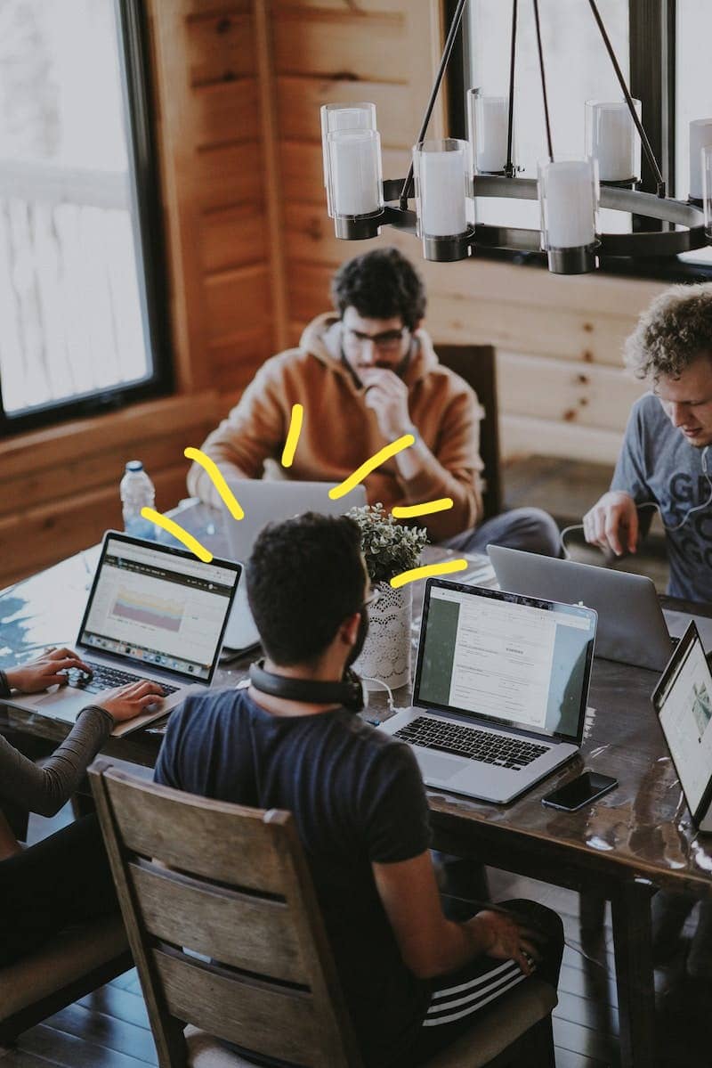 men sitting in front of their laptop computer