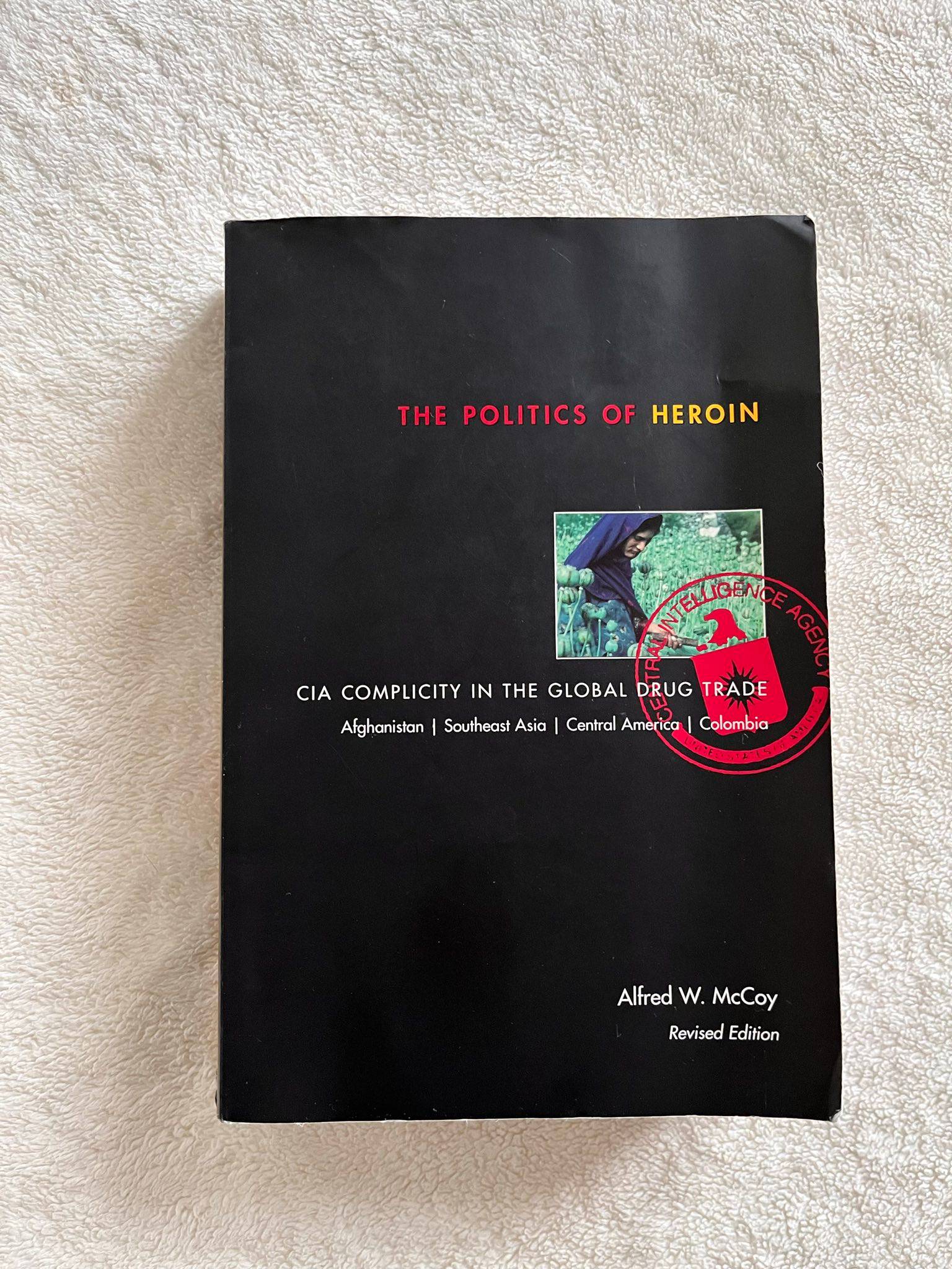 The Politics of Heroin book on a white textured blanket