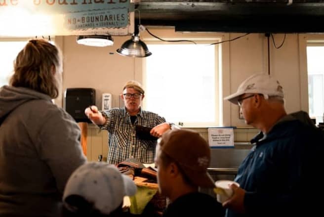 People interacting at a market stall