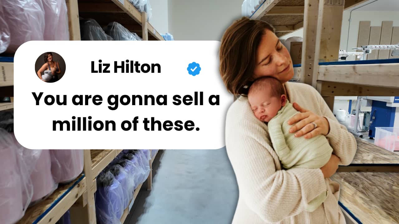 Liz Hilton, founder of KnitIt, holding her baby in her manufacturing facility in Holland, Michigan, with the NASA logo visible in the background, representing her journey from NASA writer to $3.5M baby product entrepreneur.