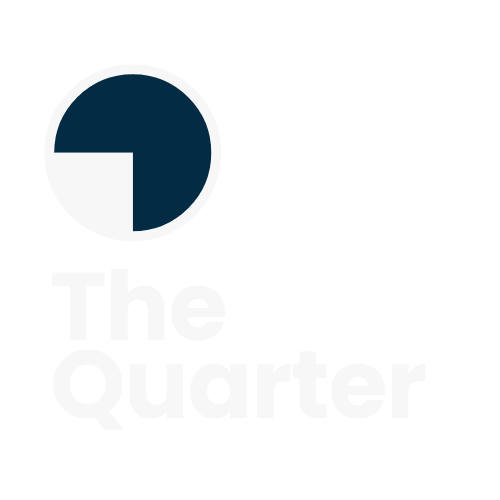 The image shows a logo for "The Quarter." The design features a circular icon where approximately three-quarters of the circle is filled with a dark navy blue color, while the remaining quarter (positioned in the bottom-left) is white or empty. Below this icon is the text "The Quarter" in a light, minimalist font. The overall design is simple, modern, and uses a clean color scheme of navy and white.