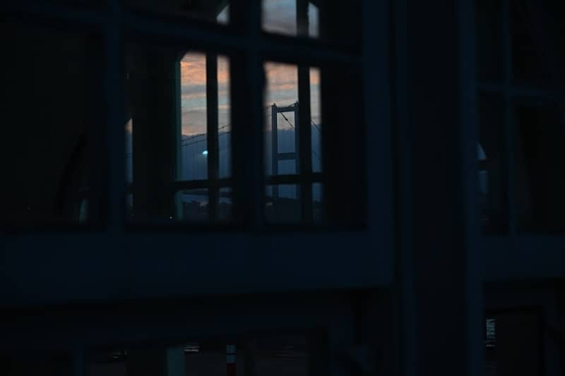 Sunset visible through a modern building's windows.