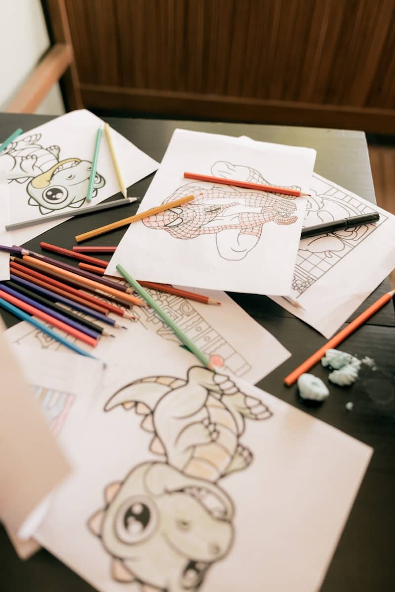 Coloring pages with crayons scattered on a table