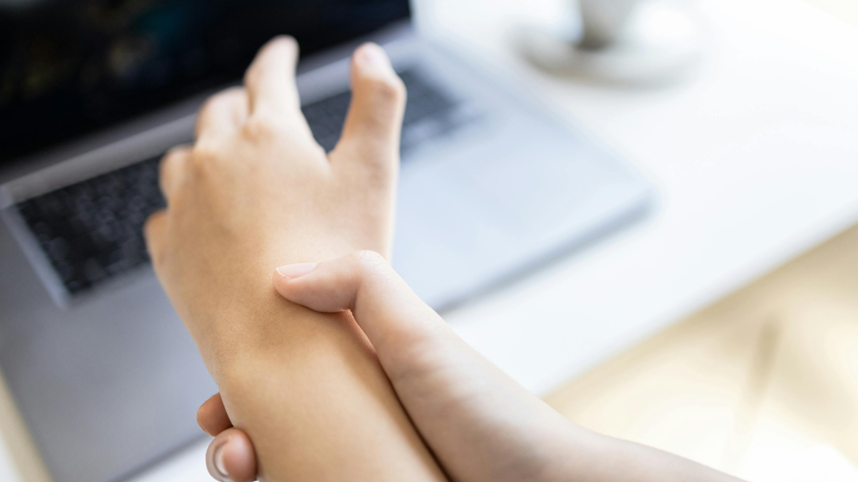 A patient holding their wrist in pain