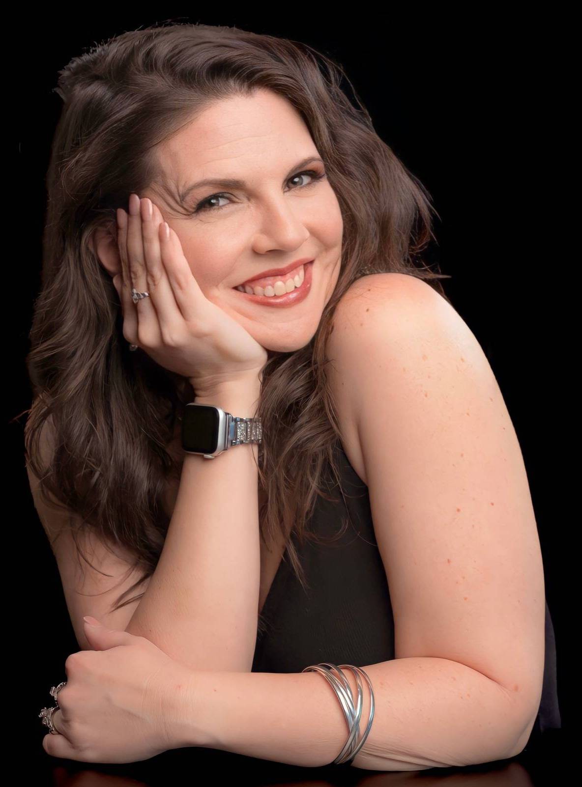Woman in sunglasses laughing outdoors