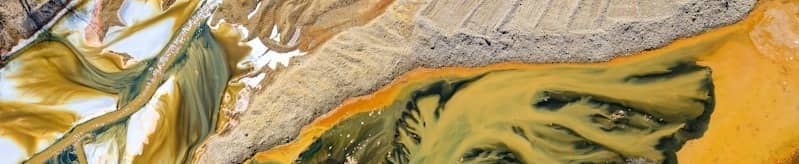 Aerial view of colorful industrial waste creating abstract patterns.