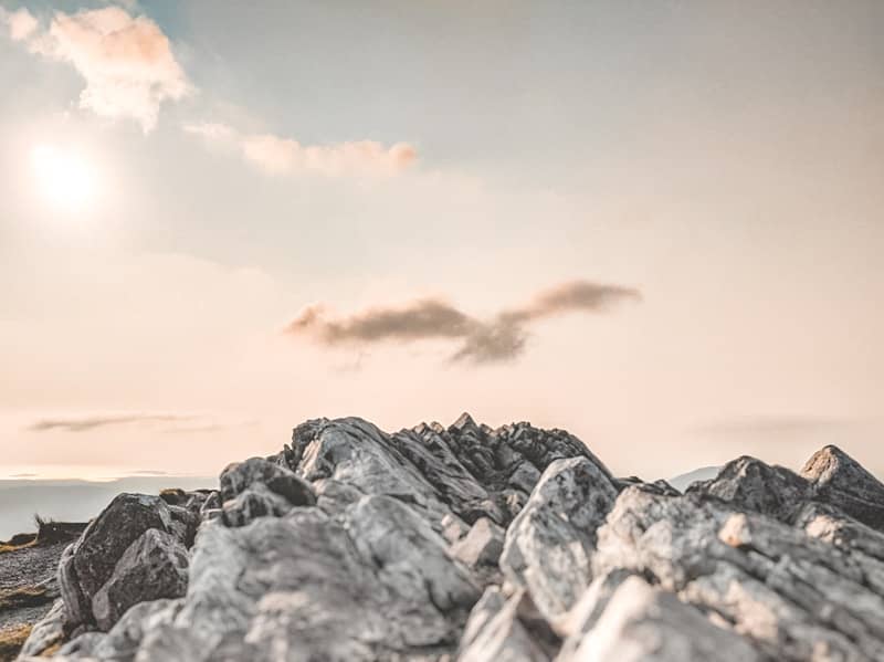 Rocky peaks stand beneath a cloudy sky.