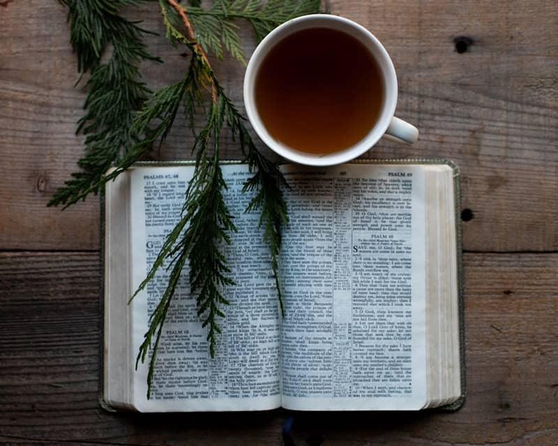 A cup of tea sitting on top of an open book