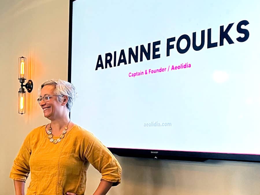 Arianne speaking at an in-person event