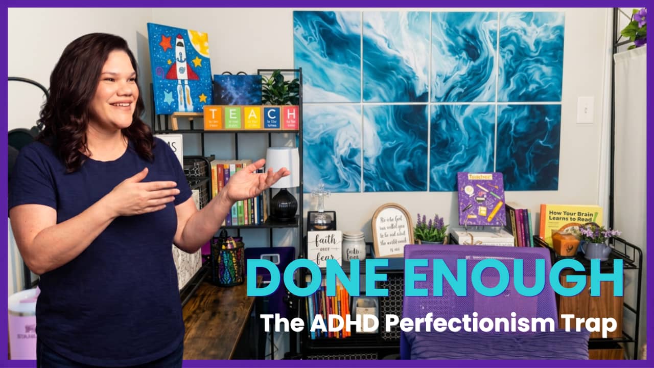 Kelly Sutherland stands in her recording studio gesturing expressively with both hands and smiling. Behind her are bookshelves with colorful educational materials, a TEACH sign, and a large teal abstract wall art installation. Bold teal text reads "DONE E