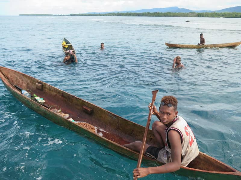 Youth collecting sea cucumbers in the Solomon Islands.