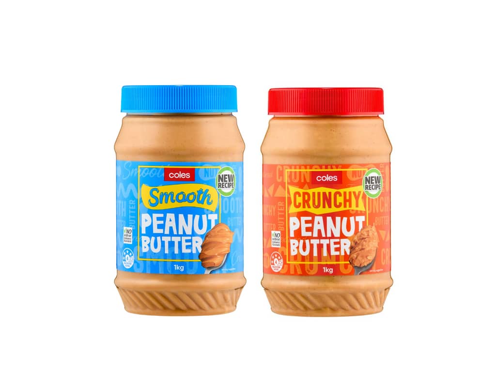 Two 1kg Coles peanut butter jars side by side - one smooth peanut butter with blue lid and blue label, one crunchy peanut butter with red lid and red label, both showing 'NEW RECIPE' badges and Coles branding.